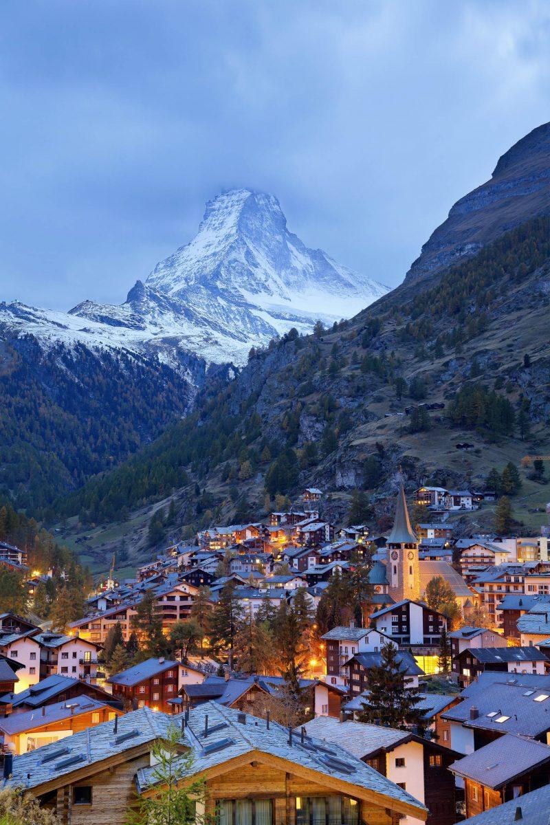 The mighty peak of the almost 4,500m high Matterhorn towers above the Swiss mountain resort of Zermatt - © Rudy Balasko / Shutterstock